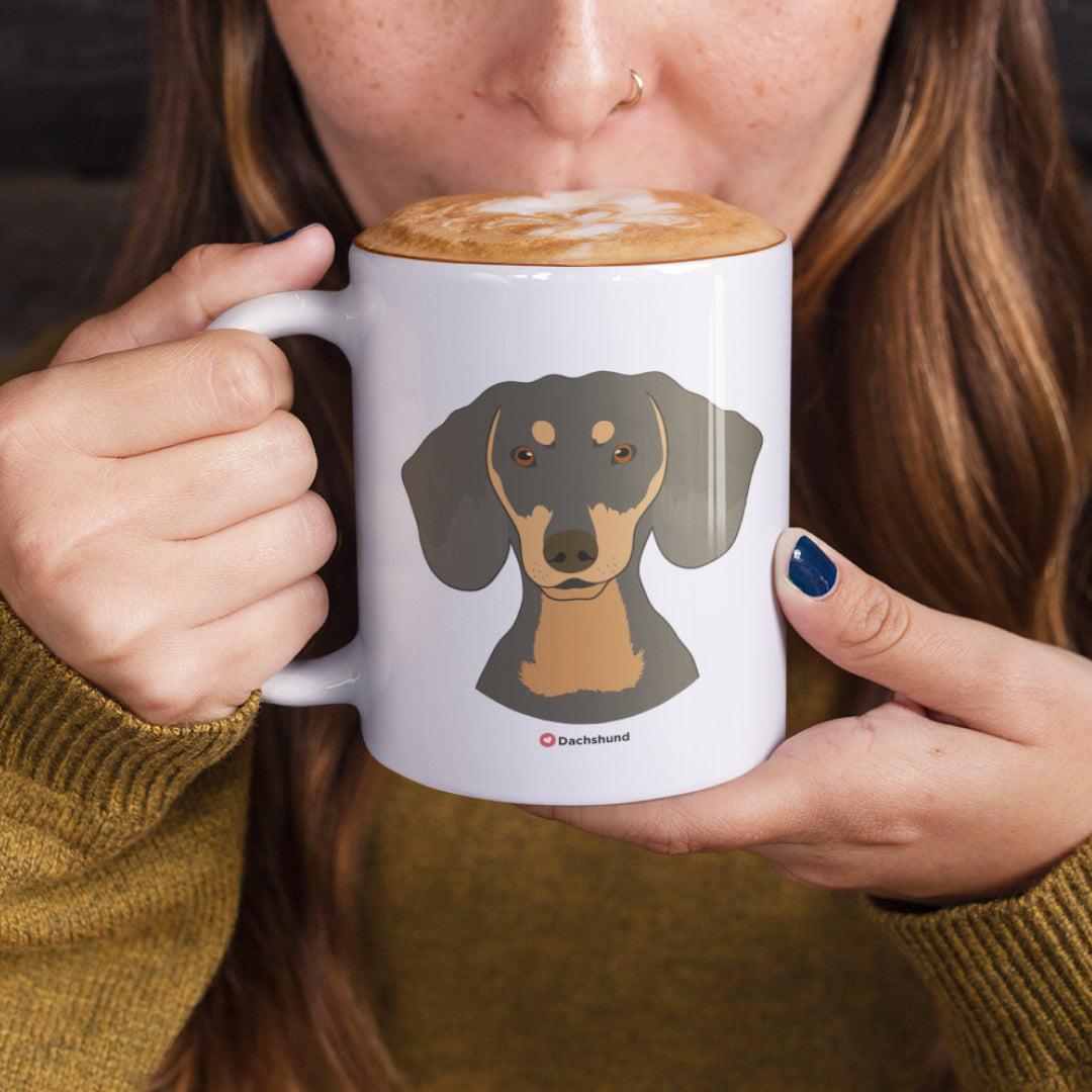 A woman holding a white 11oz ceramic mug featuring Dachshund Dog art printed on both sides