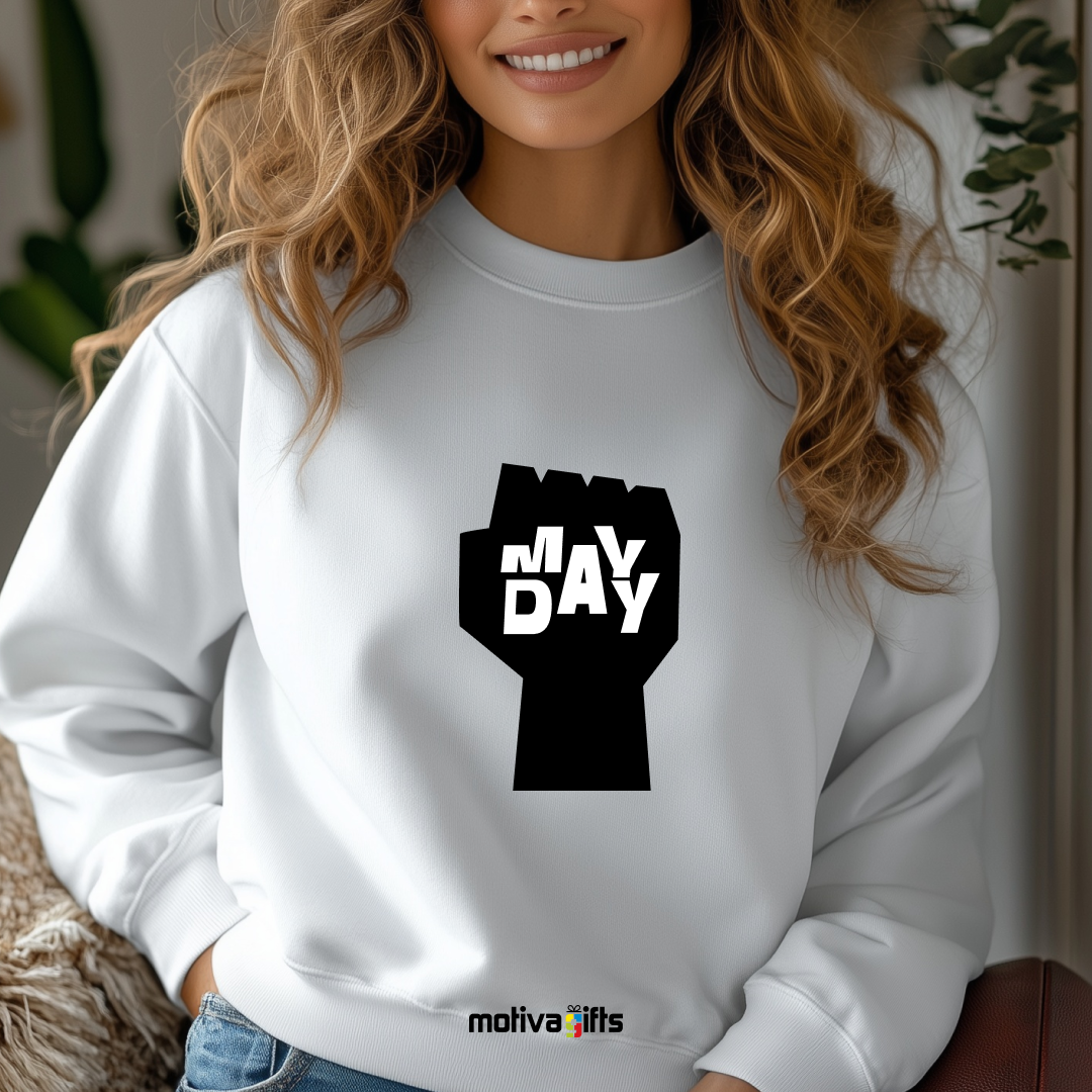 A woman wearing a white sweatshirt featuring bold black typography that reads May Day