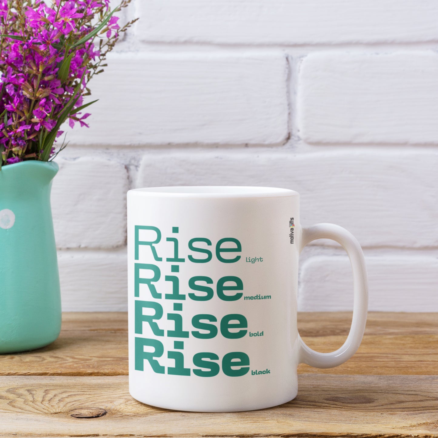 Rise White Ceramic Mug featuring a rustic table and a small vase of flower