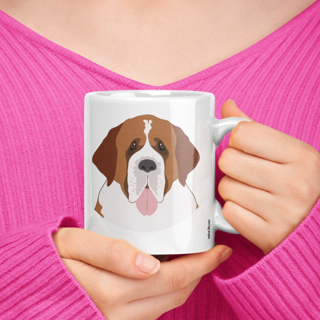 A woman holding a white 11oz ceramic mug featuring St. Bernard Dog art printed on both sides