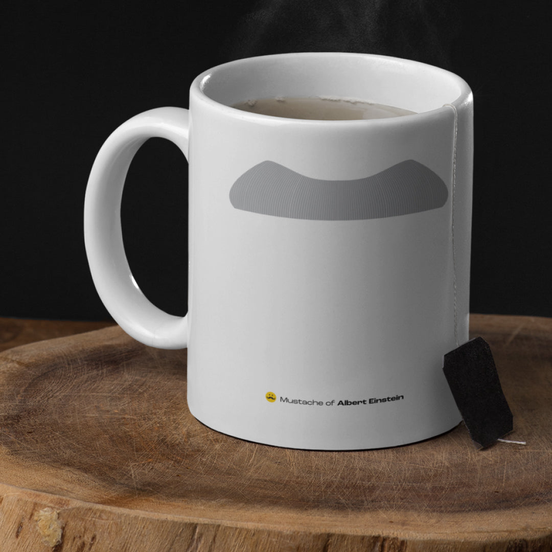 White ceramic mug with a drawing of Albert Einstein’s mustache featuring a rustic table