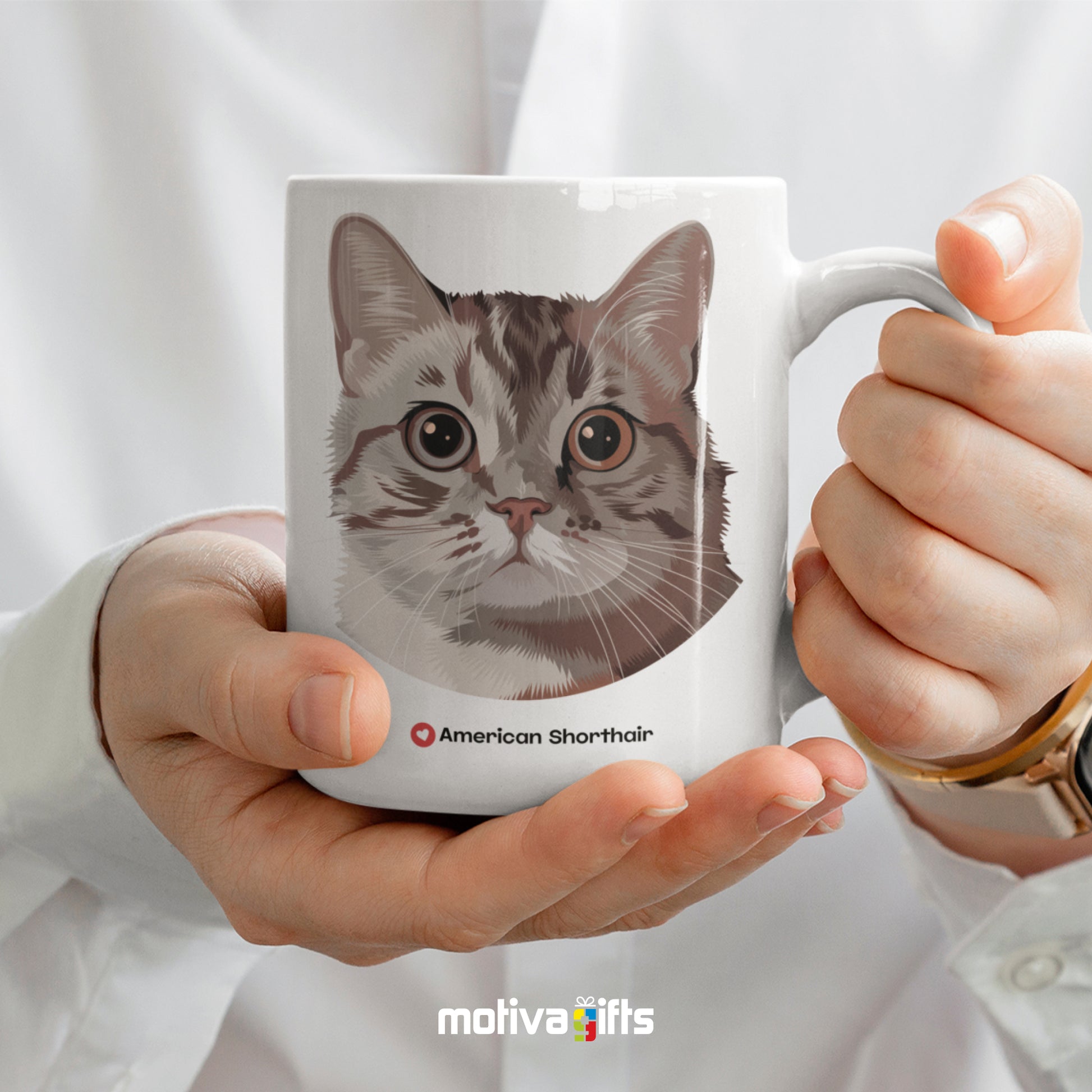 A woman holding a white 11oz ceramic mug featuring American Shorthair cat love art printed on both sides