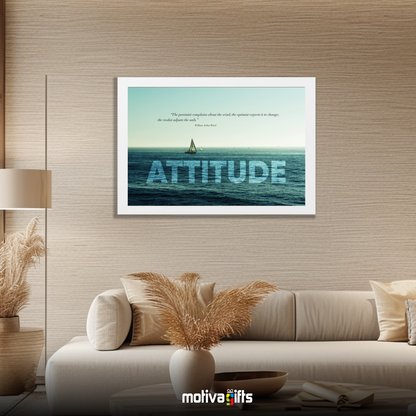 A white framed art wall with the word ATTITUDE in large text and a William Ward quote hangs in a modern living room