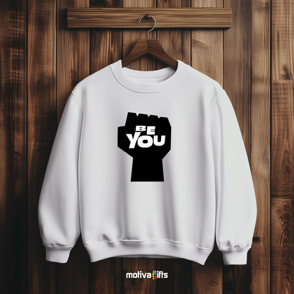 A hanging white sweatshirt featuring bold black typography that reads Be You 