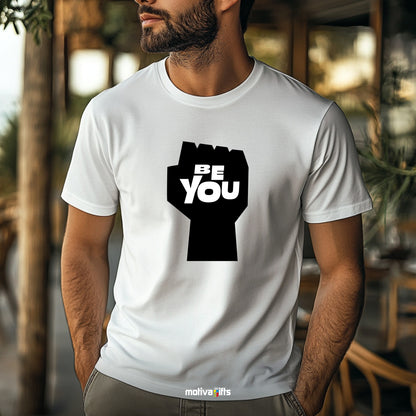 A man wearing a white T-shirt featuring bold black typography that reads Be You 