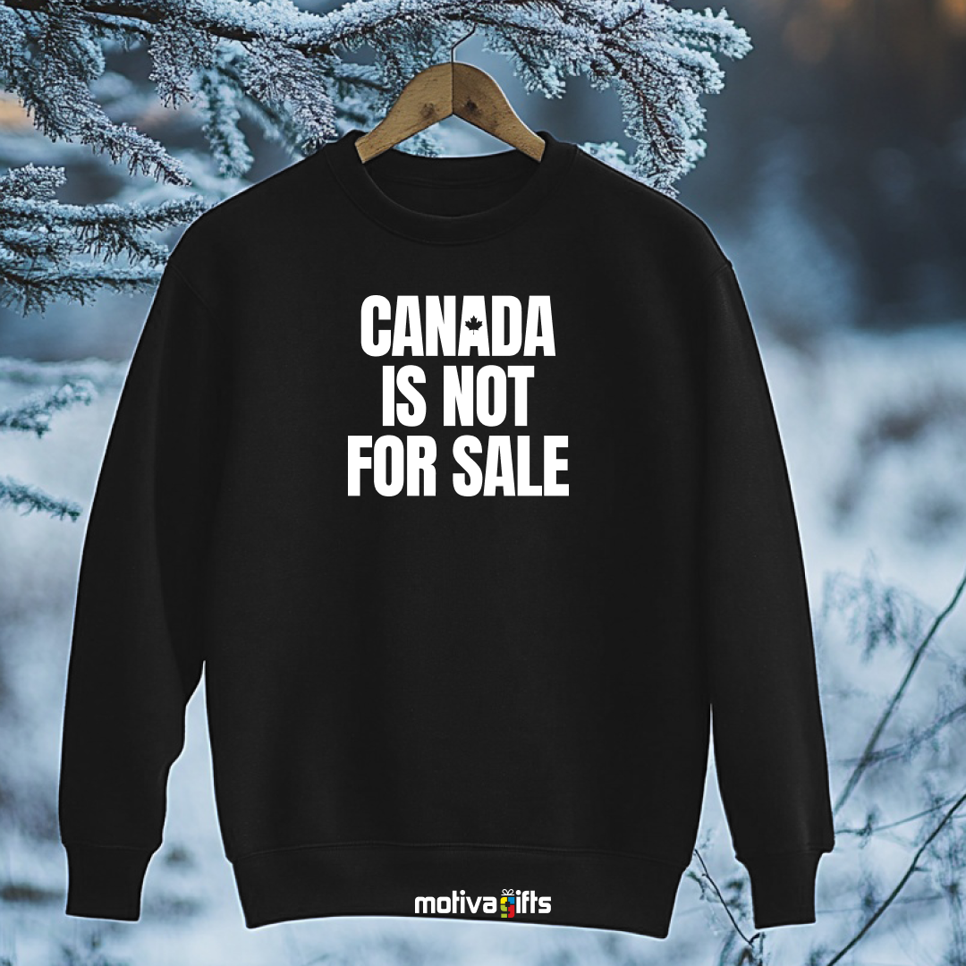 A hanging black sweatshirt featuring bold white typography that reads Canada is Not for Sale