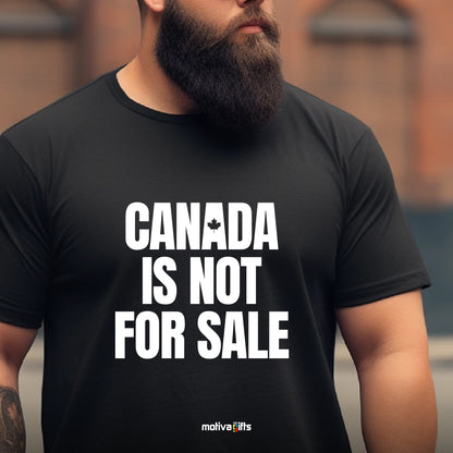 A man wearing a black T-shirt featuring bold white typography that reads 'Canada is Not for Sale