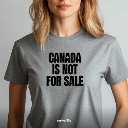 A woman wearing a grey T-shirt featuring bold black typography that reads Canada is Not for Sale