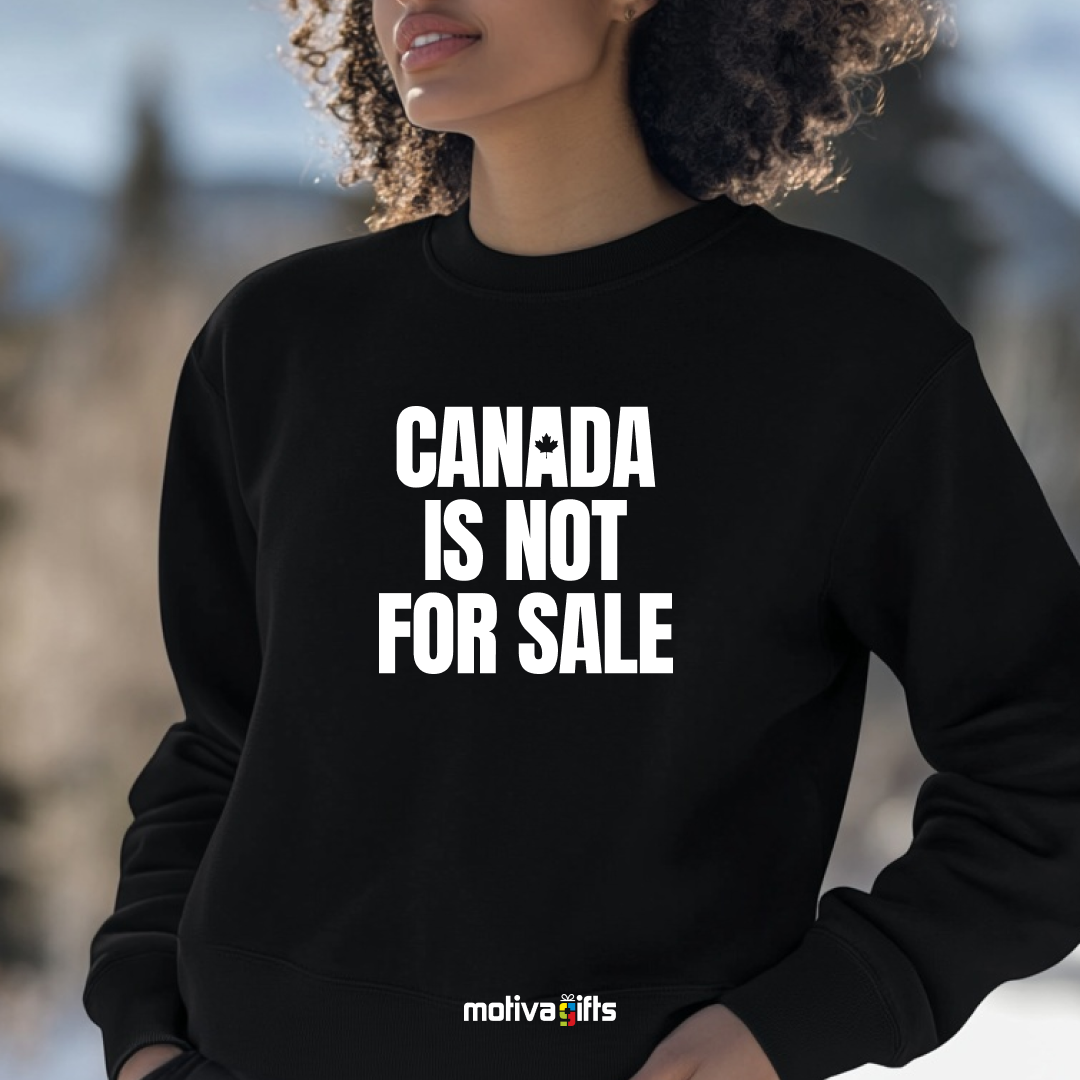 A woman wearing a black crewneck sweatshirt featuring bold white typography that reads Canada is Not for Sale