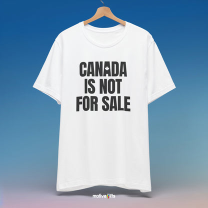 A hanging white T-shirt featuring bold black typography that reads Canada is Not for Sale