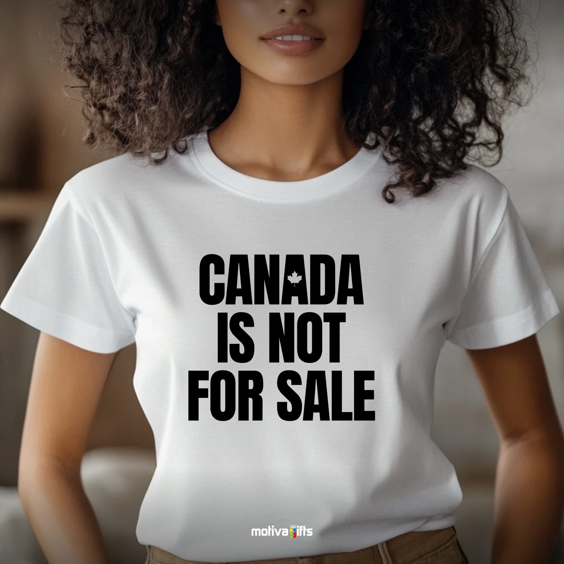 A woman wearing a white T-shirt featuring bold black typography that reads Canada is Not for Sale