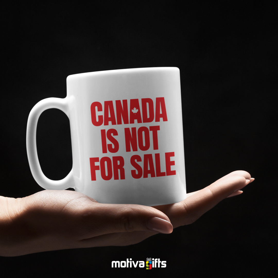 Canada is Not For Sale reads in Red bold letters on a white 11 oz ceramic mug, featuring a white table.