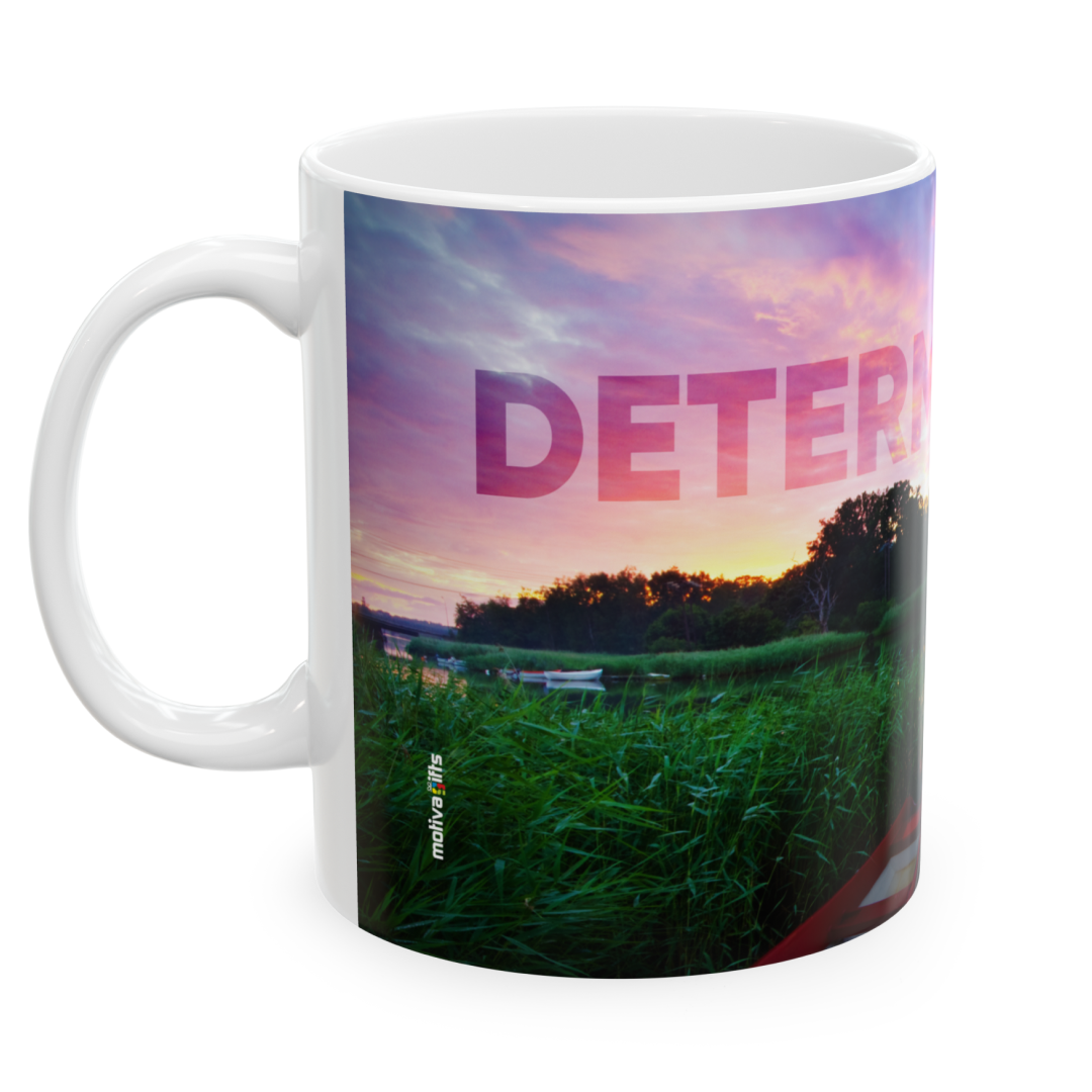 Left view of a white ceramic mug with a wraparound landscape featuring the word ‘Determination’ above a quote by Confucius: ‘Wherever you go, go with all your heart’. Set against a plain white background.