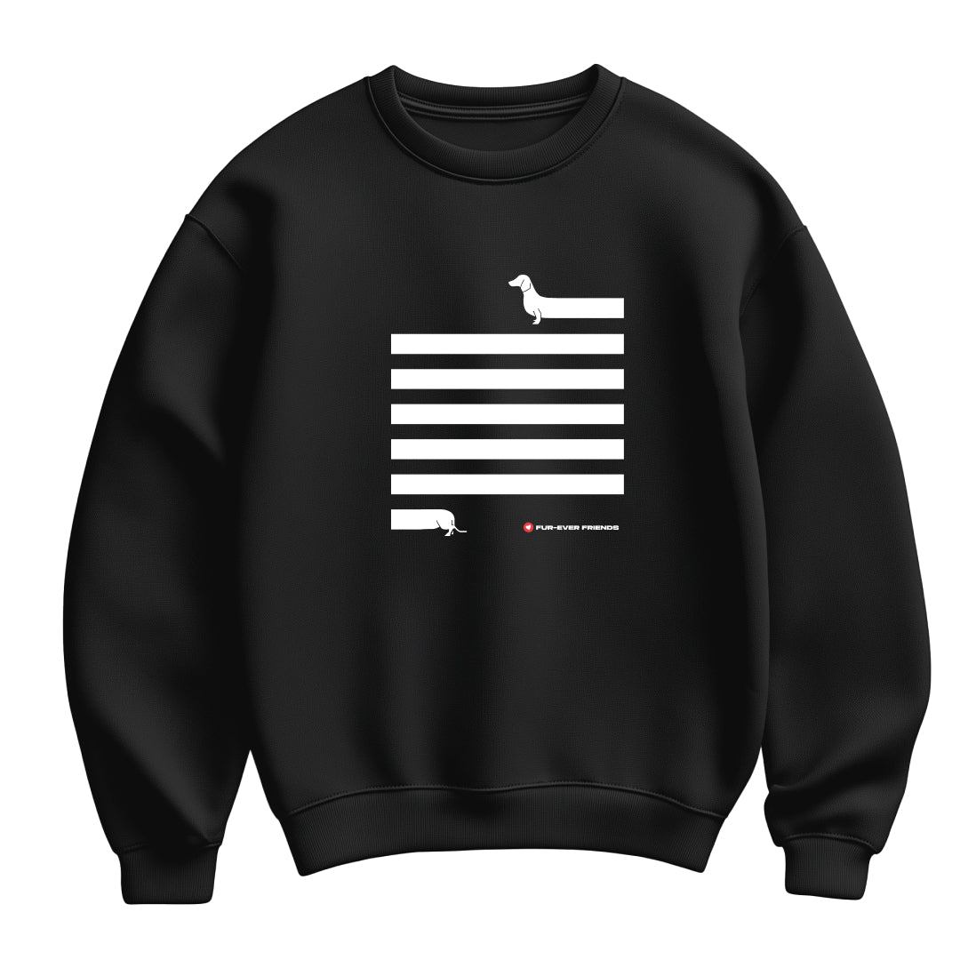 Flat lay view of a unisex black Dachshund Long on Charm Black Sweatshirt featuring a illustration of a dachshund with an extra-long body and quirky charm