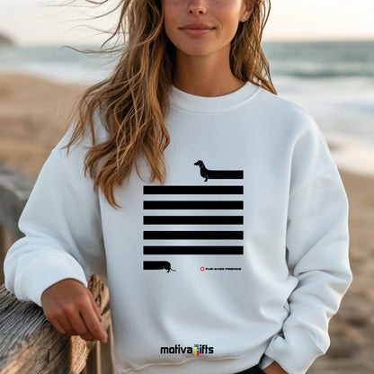 A woman wearing a White Dachshund Long on Charm White Sweatshirt featuring a illustration of a dachshund with an extra-long body and quirky charm