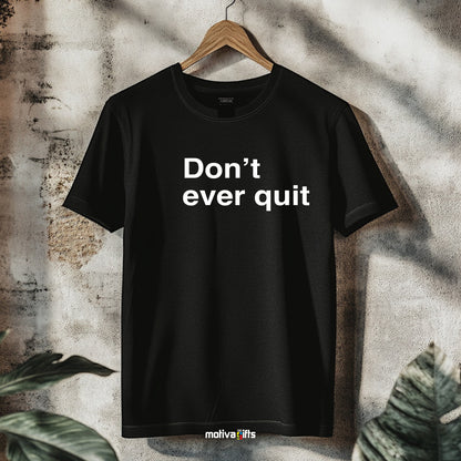 A hanging black T-shirt featuring bold white typography that reads Don’t ever quit 