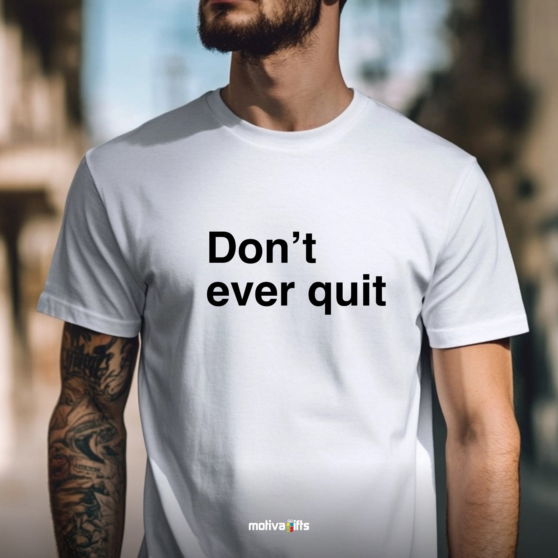 A man wearing a white T-shirt featuring bold black typography that reads Don’t ever quit 