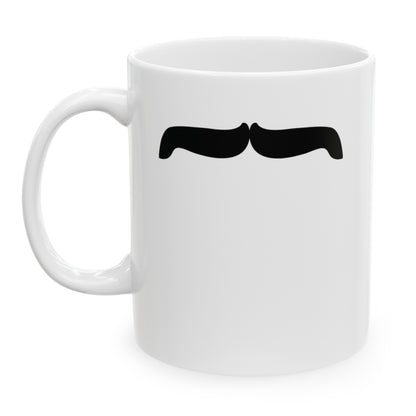 Photo of a white ceramic mug with a drawing of Freddie Mercury’s mustache, set against a plain white background.