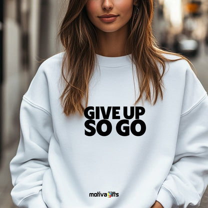 A woman wearing a white flat-lay Sweatshirt with black typography that reads Give Up So Go
