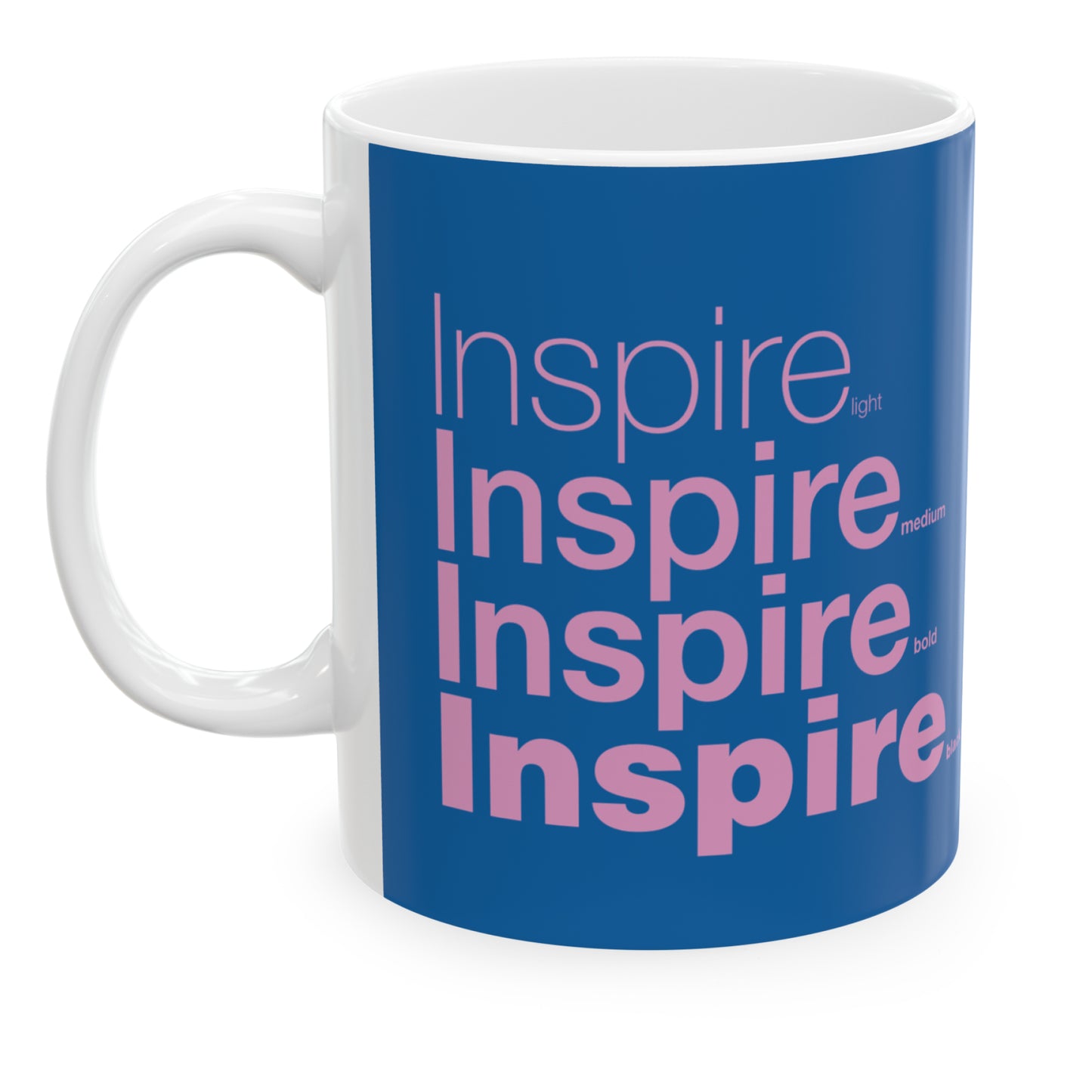 white ceramic mug with a blue wraparound design and the word 'Inspire' printed in pink in four typography styles: light, medium, bold, and black. clean white background.