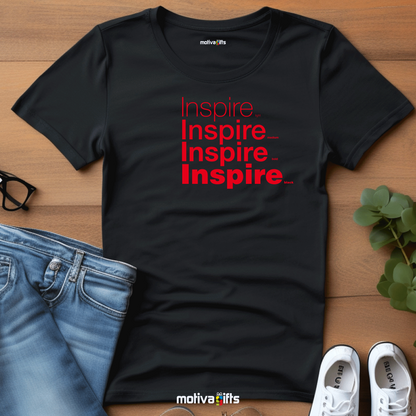 Flatlay image of a Black unisex t-shirt with Inspire printed in red on the front in four lines with different font weights (light, medium, bold, black). Made of cotton and polyester, short sleeves, crew neck. By Motiva Gifts.