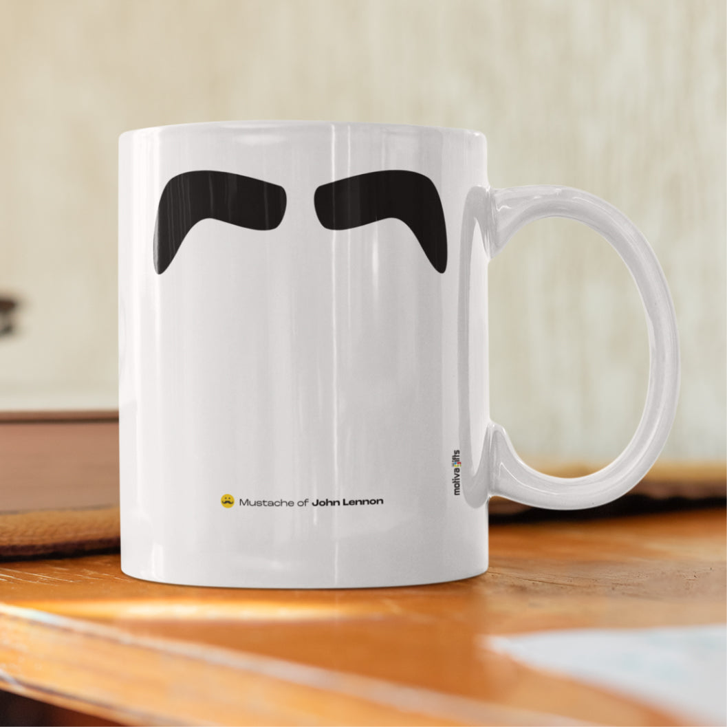 White ceramic mug with a drawing of John Lennon's mustache featuring a rustic table. 