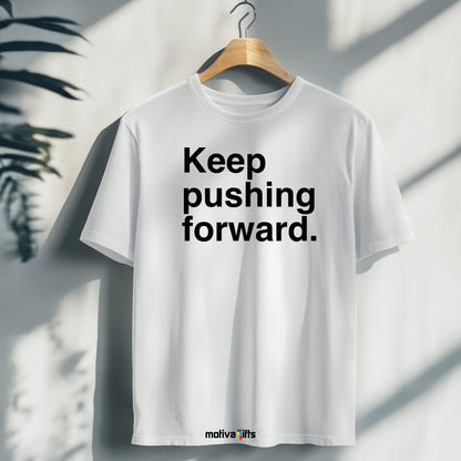 A hanging white T-shirt featuring bold black typography that reads Keep pushing forward 