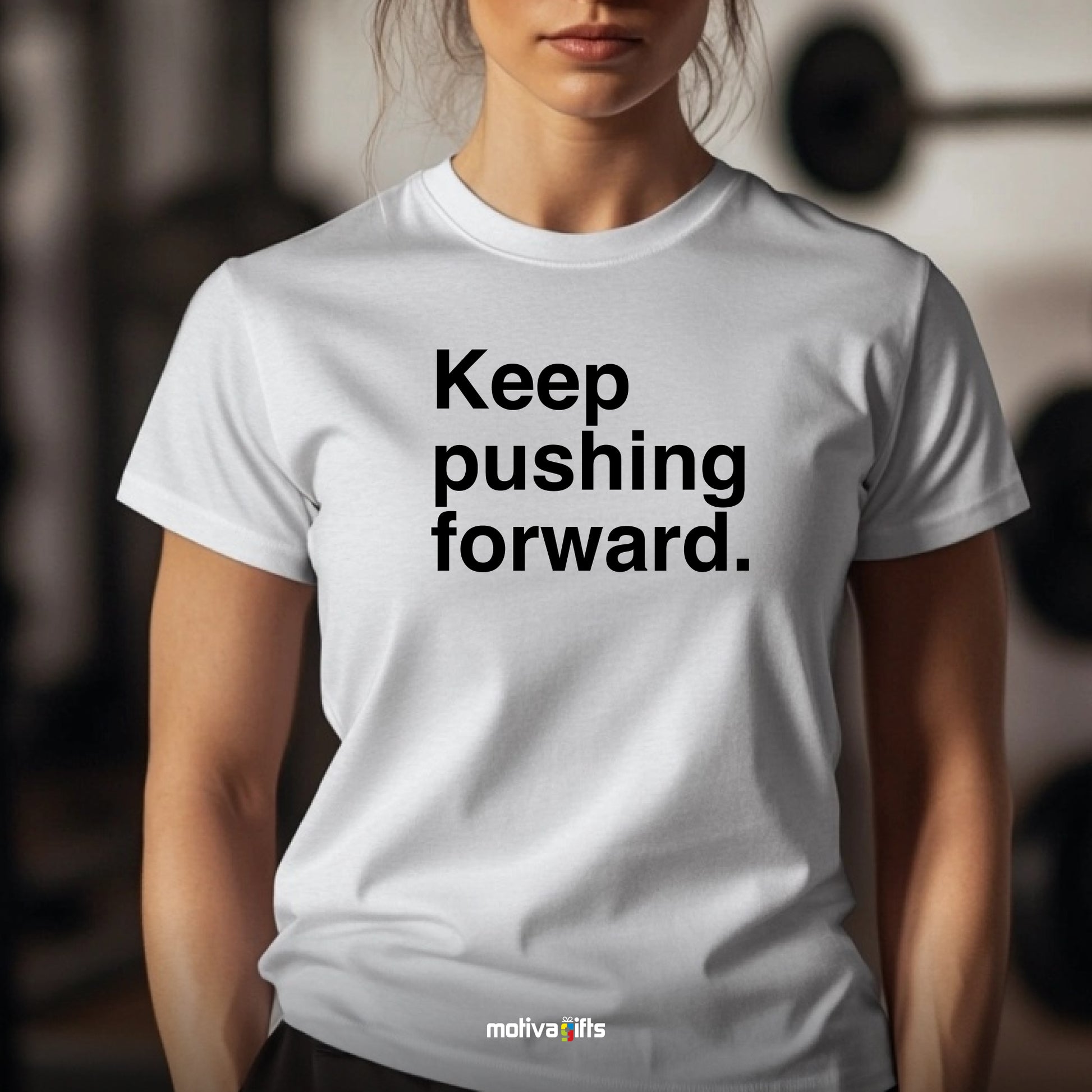 A woman wearing a white T-shirt featuring bold black typography that reads Keep pushing forward