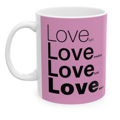 White ceramic mug with a pink wraparound design and the word 'Love' printed in black in four typography styles: light, medium, bold, and black. Clean white background.