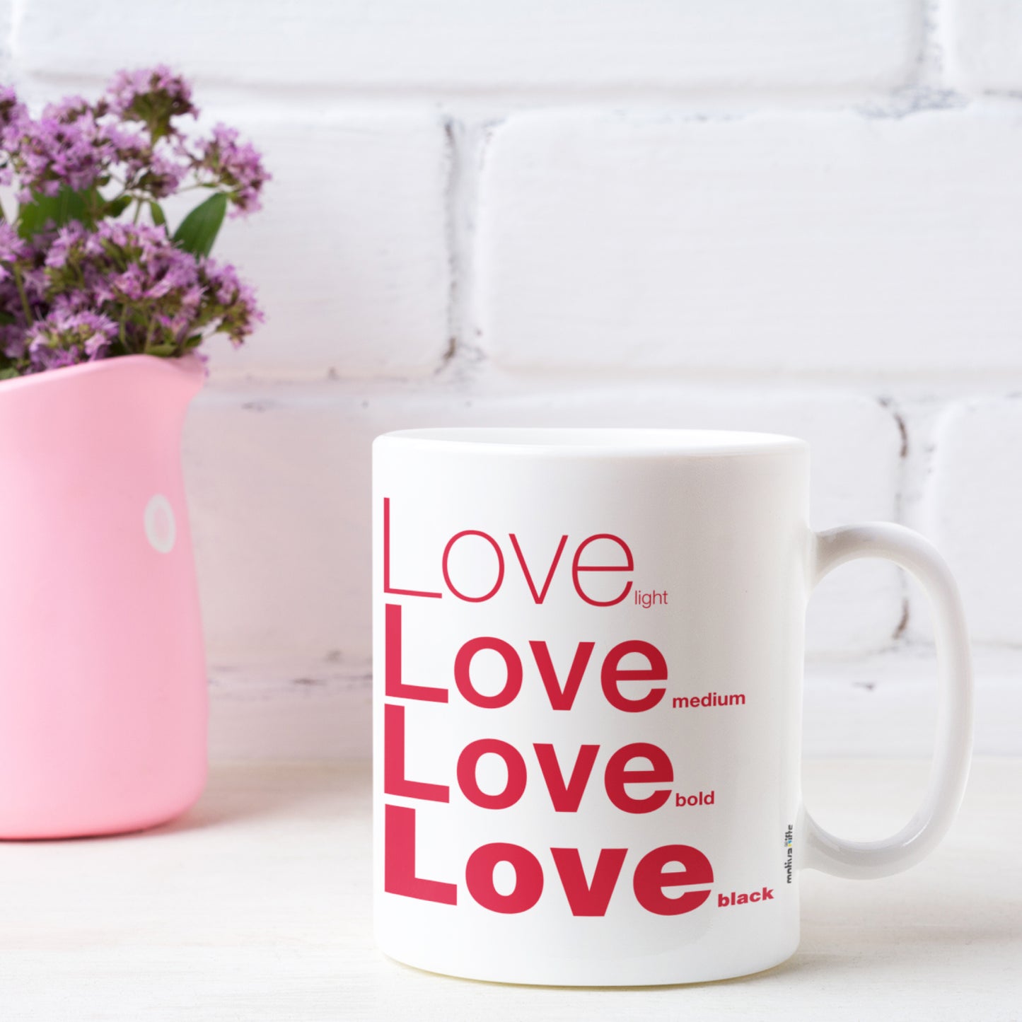 Love White Ceramic Mug featuring a rustic table and a small vase of flower