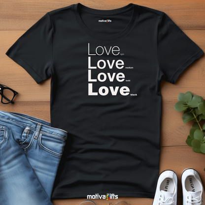 Flatlay image of a black unisex t-shirt with Love printed in white on the front in four lines with different font weights (light, medium, bold, black). Made of cotton and polyester, short sleeves, crew neck. By Motiva Gifts.