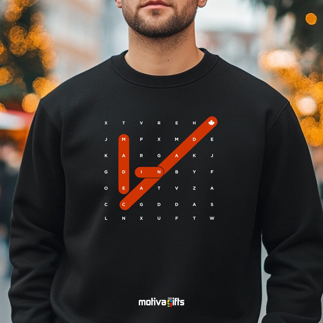 A man wearing of a Crossword black T-shirt featuring bold white typography that reads Made in Canada