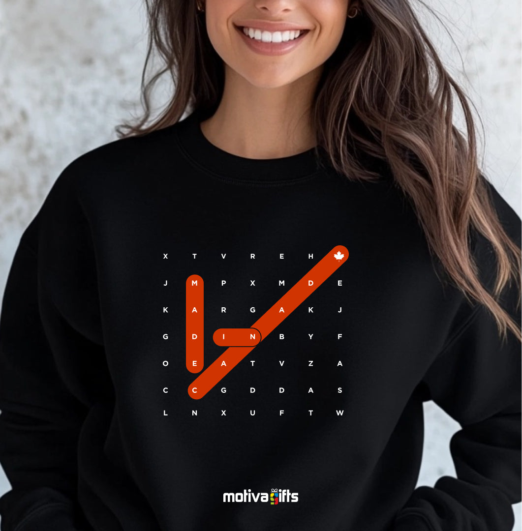 A woman wearing of a Crossword black T-shirt featuring bold white typography that reads Made in Canada