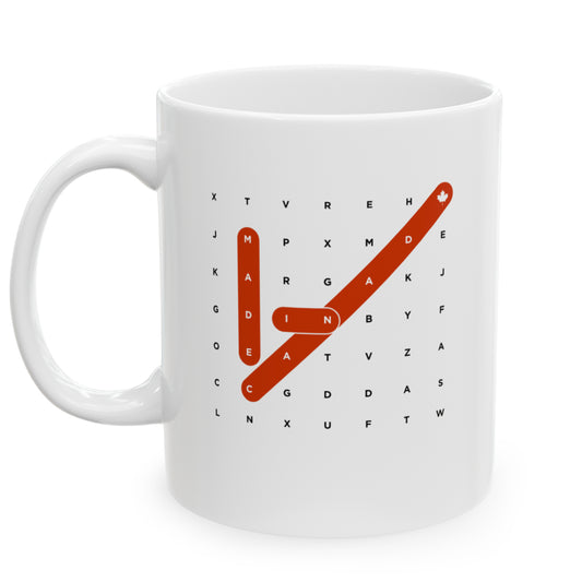 Left view white ceramic 11 oz mug that reads in black/red bold Made in Canada Crosswords