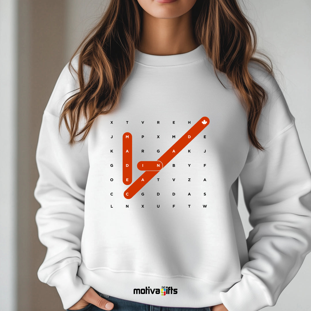 A woman wearing of a Crossword white T-shirt featuring bold white typography that reads Made in Canada