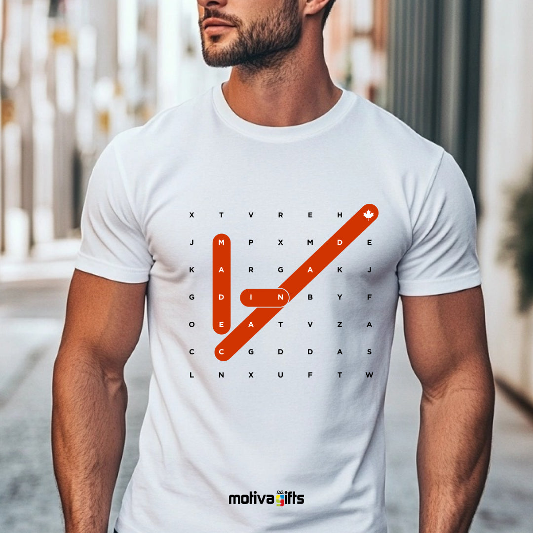 A man wearing a white T-shirt featuring bold white and red typography that reads Made in Canada Crossword