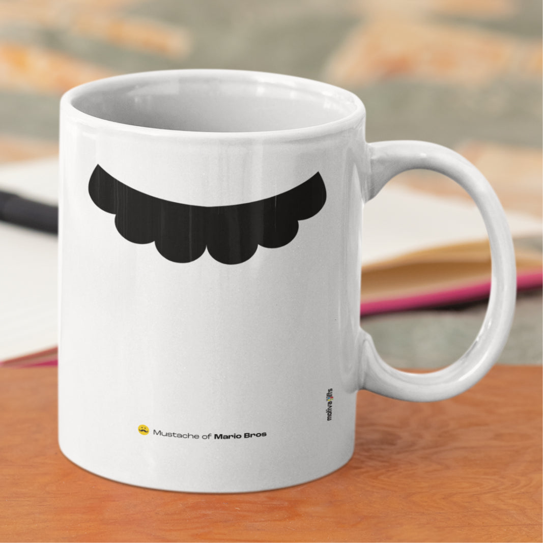 White ceramic mug with a drawing of Mario Bros’s mustache featuring a rustic table