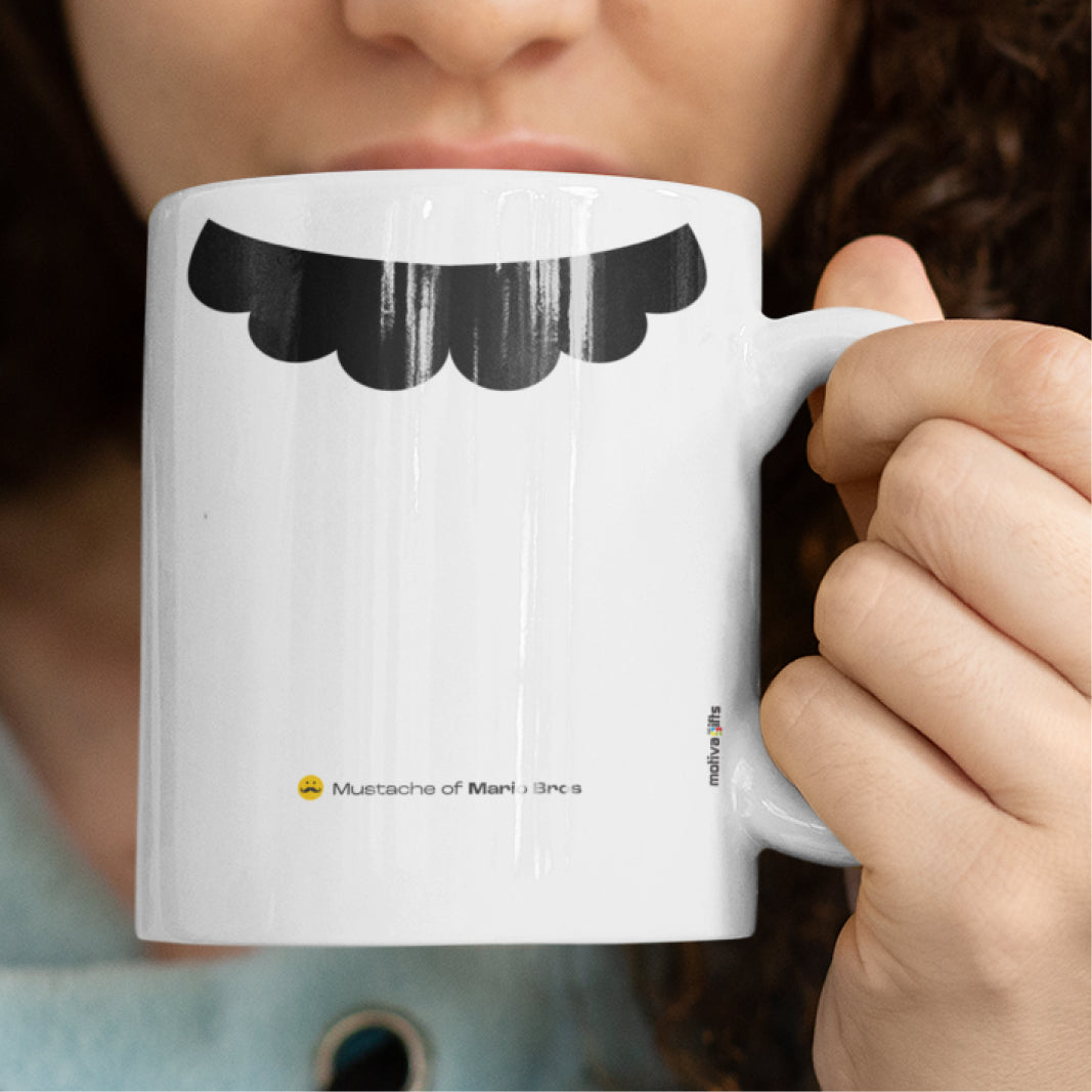 Woman holding a white ceramic mug with a drawing of Mario Bros’s mustache