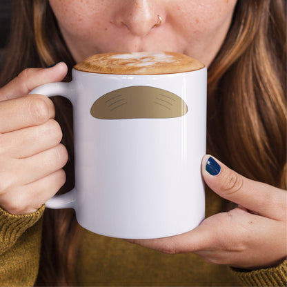 Woman holding a white ceramic mug with a drawing of Ned Flander’s mustache