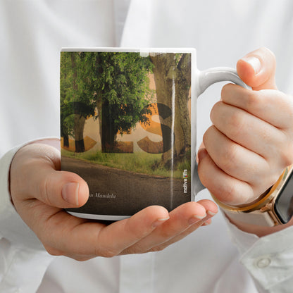 Woman holding a white ceramic mug with a wraparound design displaying the word ‘Choices’ above a quote by Nelson Mandela: ‘May your choices reflect your hopes, not your fears’