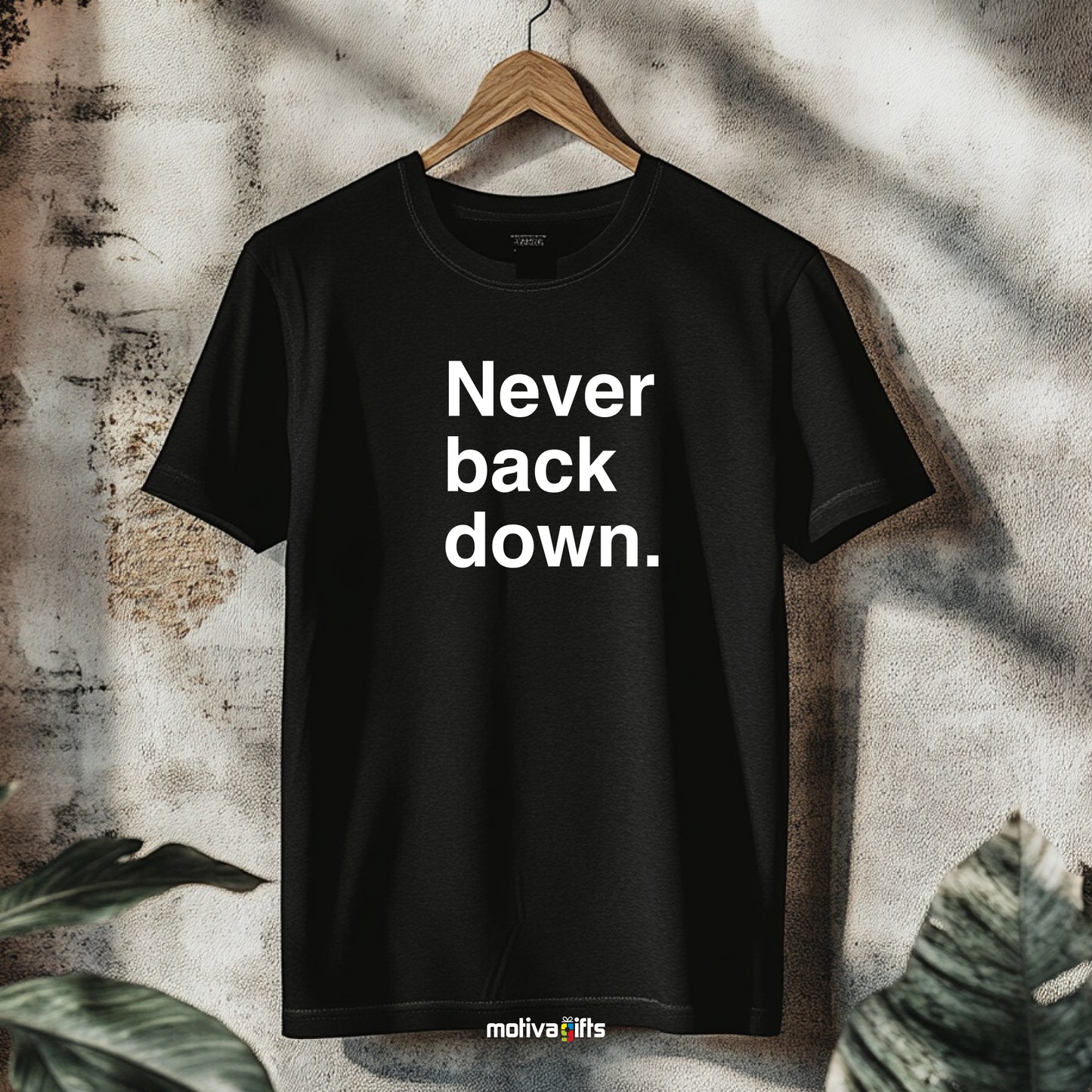 A hanging black T-shirt featuring bold white typography that reads Never back down