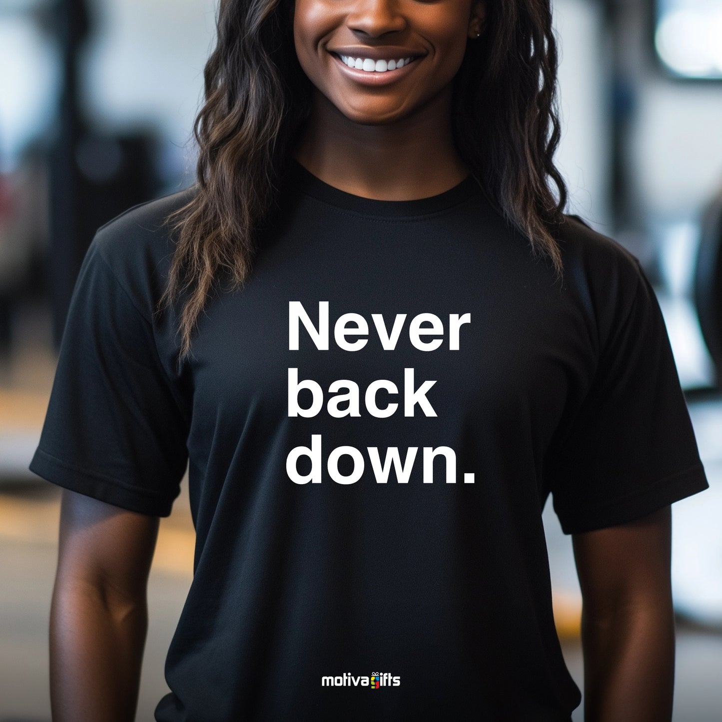 A woman wearing a black T-shirt featuring bold white typography that reads Never back down