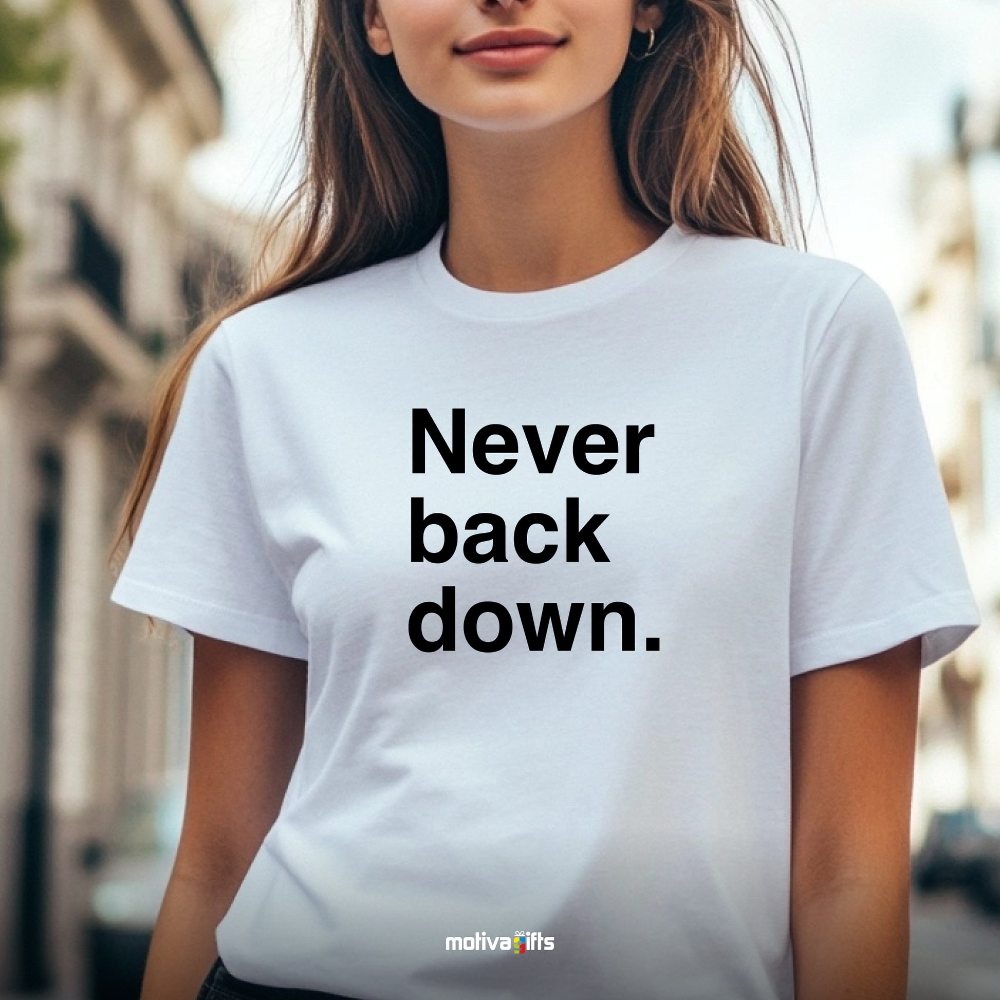 A woman wearing a white T-shirt featuring bold black typography that reads Never back down