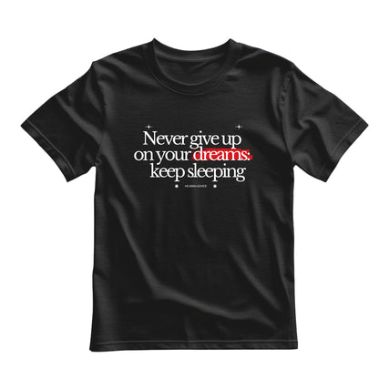 Black flat-lay T-shirt featuring white typography that reads Never give up on your dreams: keep sleeping