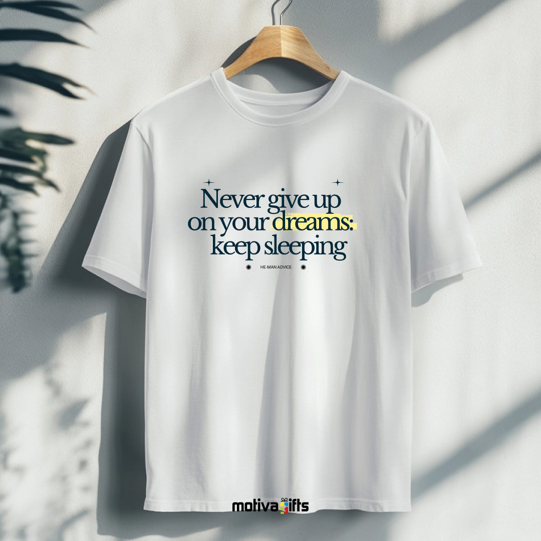 A hanging white T-shirt featuring black typography that reads Never give up on your dreams: keep sleeping