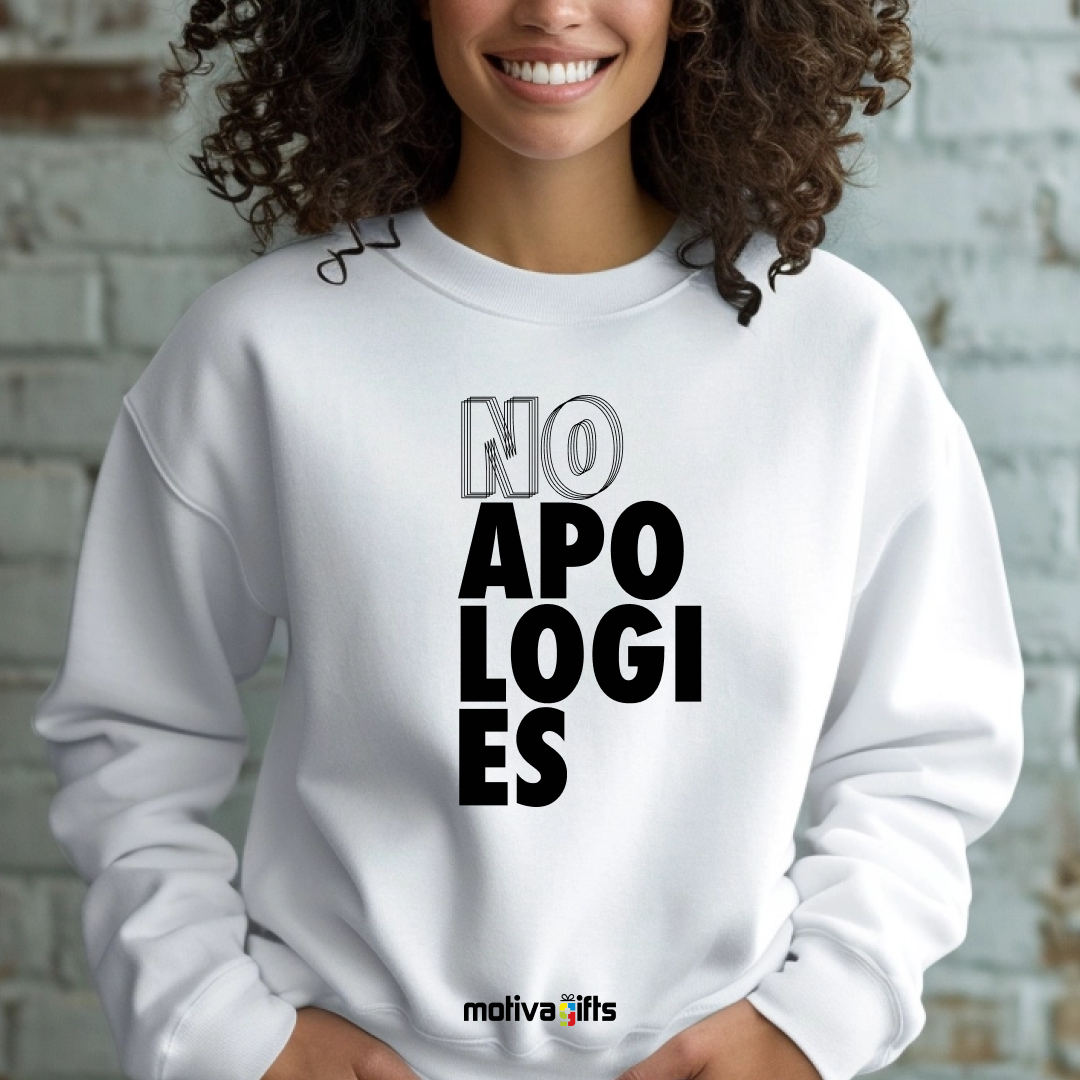 A woman wearing a white crewneck sweatshirt featuring bold black typography that reads No Apologies