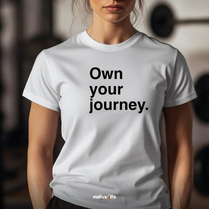 Woman wearing a white T-shirt featuring bold black typography that reads Own your journey 