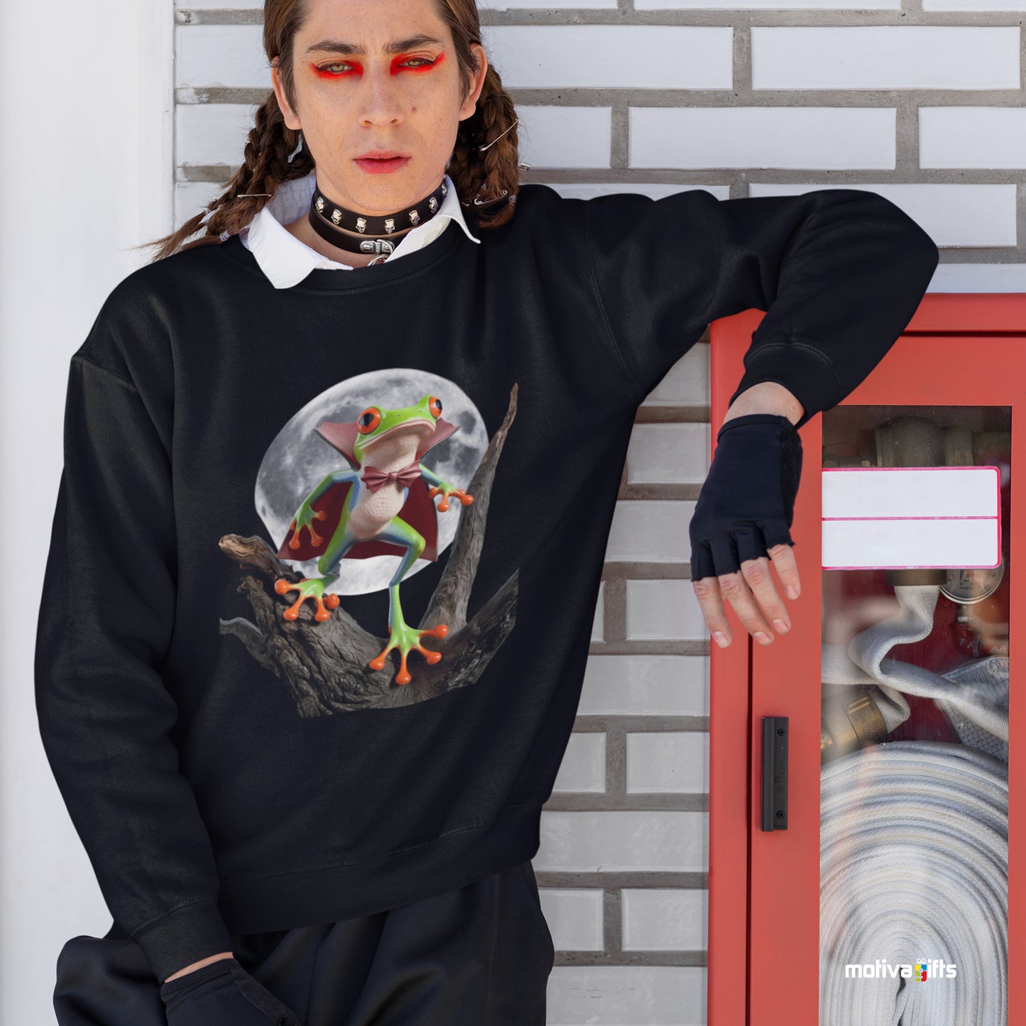 Man black sweatshirt featuring a design of a poison dart frog wearing a vampire Halloween 