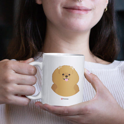 A woman holding a white 11oz ceramic mug featuring Pomeranian Dog art printed on both sides