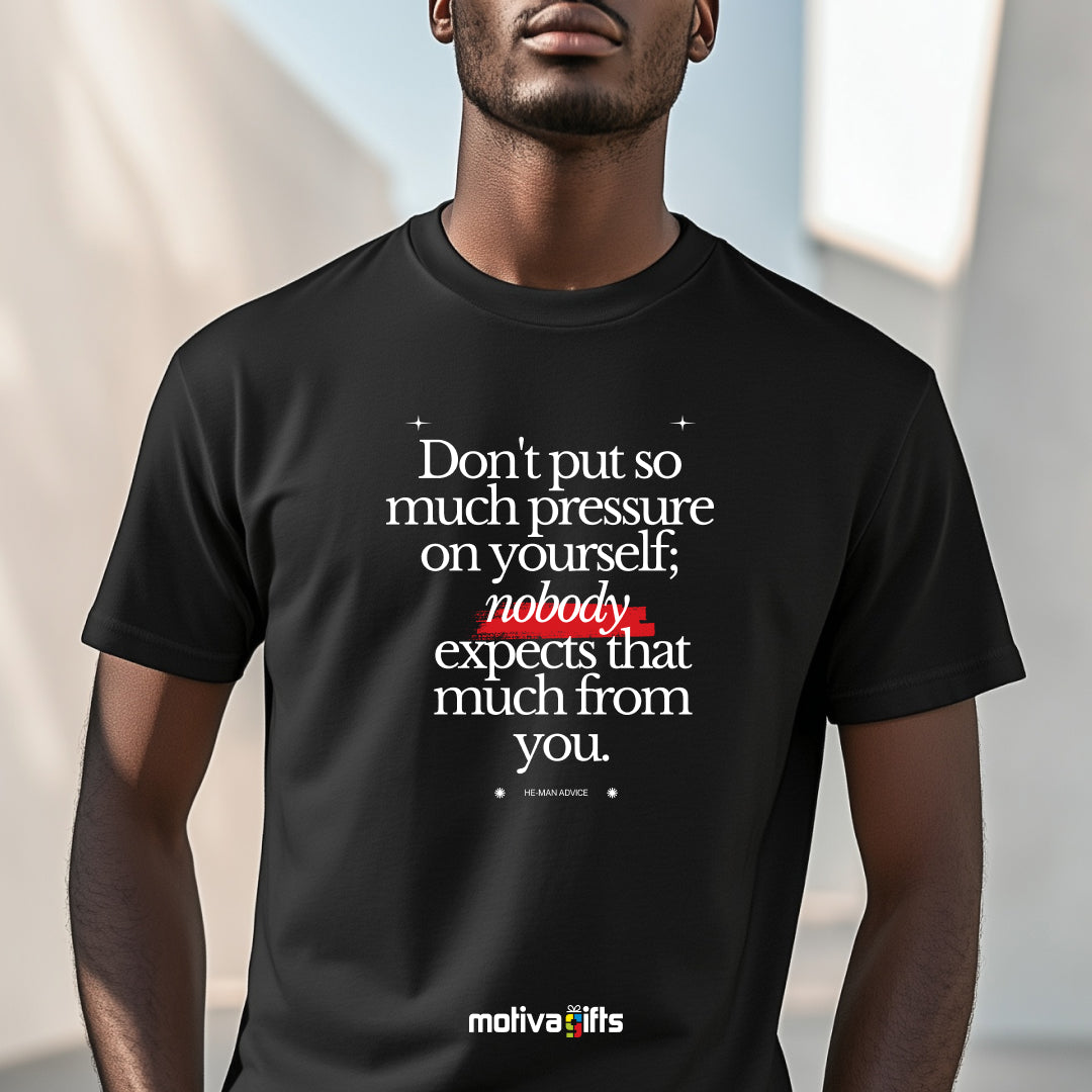 A man wearing a Black T-shirt featuring bold white typography that reads Don’t put so much pressure on yourself; nobody expects that much from you